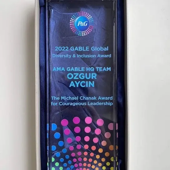 A glass trophy in a presentation box. It reads: 2022 GABLE Global Diversity and Inclusion Award, AMA GABLE HQ Team, Ozgur Aycin, The Michael Chanak Award for Courageous Leadership.